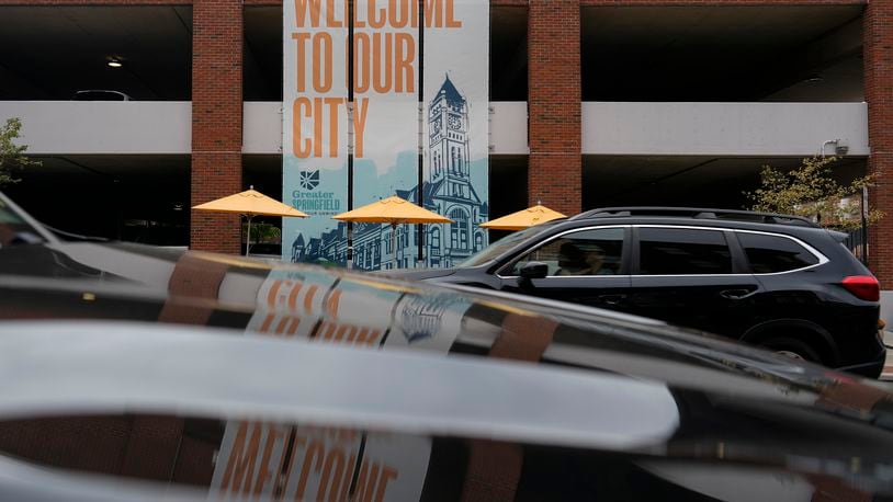 A banner with the images of the Heritage Center of Clark County and "Welcome To Our City," hangs along North Fountain Ave. Tuesday, Sept. 17, 2024, in Springfield, Ohio. (AP Photo/Carolyn Kaster)