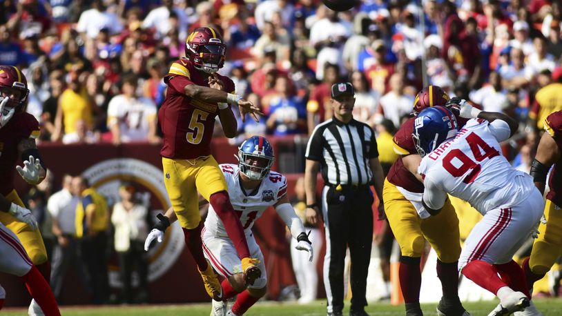 Washington Commanders quarterback Jayden Daniels (5) throws a pass against the New York Giants during the second half of an NFL football game in Landover, Md., Sunday, Sept. 15, 2024. (AP Photo/Steve Ruark)