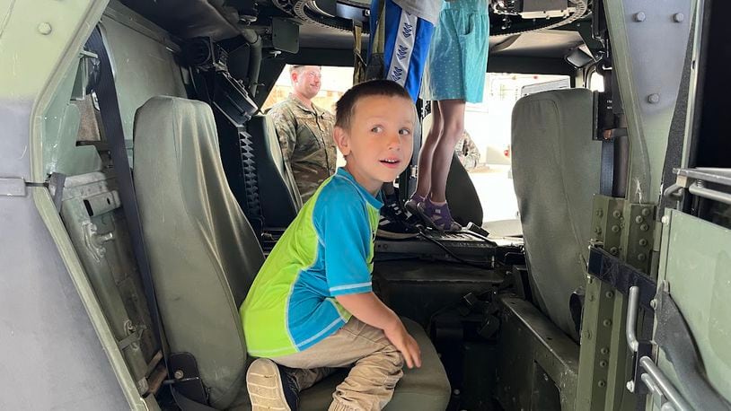 Emmett Cuccia, 4, could be seen climbing aboard a Humvee in a Wright-Patterson Air Force Base hangar at Operation K.U.D.O.S Friday morning. The event was meant to give children insights into life in military deployment for their active-duty parents. THOMAS GNAU/STAFF