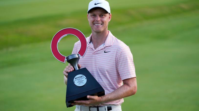 Cam Davis celebrates winning the Rocket Mortgage Classic golf tournament at Detroit Country Club, Sunday, June 30, 2024, in Detroit. (AP Photo/Paul Sancya)