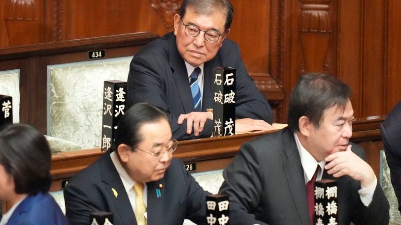 Shigeru Ishiba, top, sits ahead of the extraordinary session of parliament's lower house Tuesday, Oct. 1, 2024, in Tokyo. (AP Photo/Eugene Hoshiko)