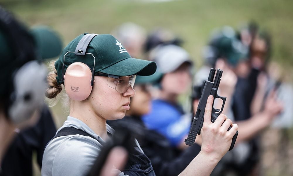 Dayton Daily News reporter London Bishop gets ready to shoot during training at the gun range. JIM NOELKER/STAFF