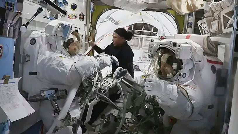 In this photo provided by NASA, astronaut Jeanette Epps (center) is pictured assisting NASA astronauts Mike Barratt (left) and Tracy Dyson (right) inside the Quest airlock. (NASA TV via AP)