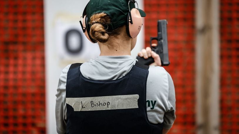 Dayton Daily News reporter London Bishop gets ready to shoot during training at the gun range. JIM NOELKER/STAFF