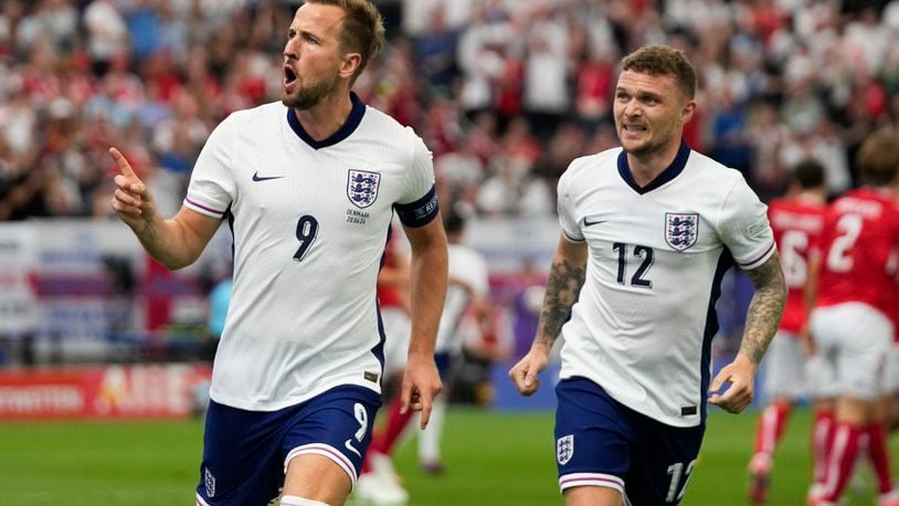 England's Harry Kane (9) celebrates with Kieran Trippier (12) after scoring a goal during a Group C match between Denmark and England at the Euro 2024 soccer tournament in Frankfurt, Germany, Thursday, June 20, 2024. (AP Photo/Themba Hadebe)