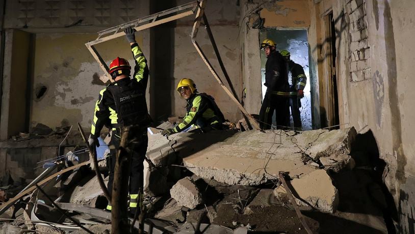 Emergency services workers move rubble after a Russian strike on a residential building in Kharkiv, Ukraine early Sunday Sept. 22, 2024. (Kharkiv Regional Military Administration via AP)