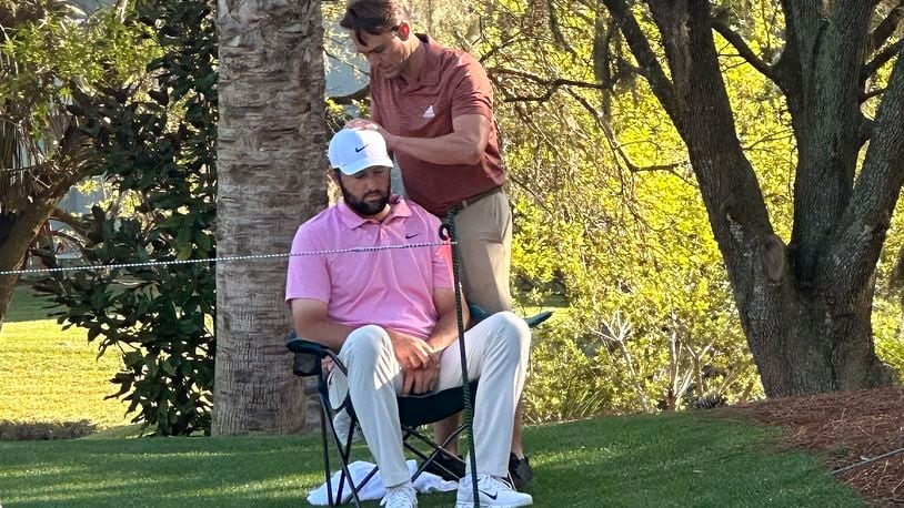 FILE - Scottie Scheffler, seated, gets treatment as he waits to tee off on the 14th hole during the second round of The Players Championship golf tournament Friday, March 15, 2024, in Ponte Vedra Beach, Fla. Scheffler went on to win the tournament. (AP Photo/Doug Ferguson)