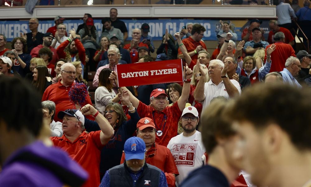 Dayton fans celebrate a victory against LSU in the first round of the Charleston Classic on Thursday, Nov. 16, 2023, at TD Arena in Charleston, S.C. David Jablonski/Staff