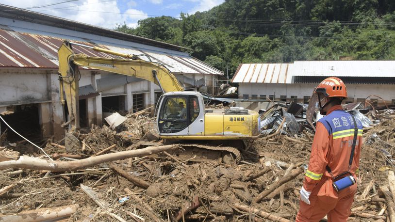 In this photo released by Xinhua News Agency, rescuers clear debris in a flood-affected area in Sishui Township of Pingyuan County, Meizhou City, southern China's Guangdong Province, June 20, 2024. Several people have died and others are missing after downpours caused historic flooding in rural parts of Guangdong province in southern China, while authorities warned Friday of more flooding ahead in other parts of the country. (Lu Hanxin/Xinhua via AP)