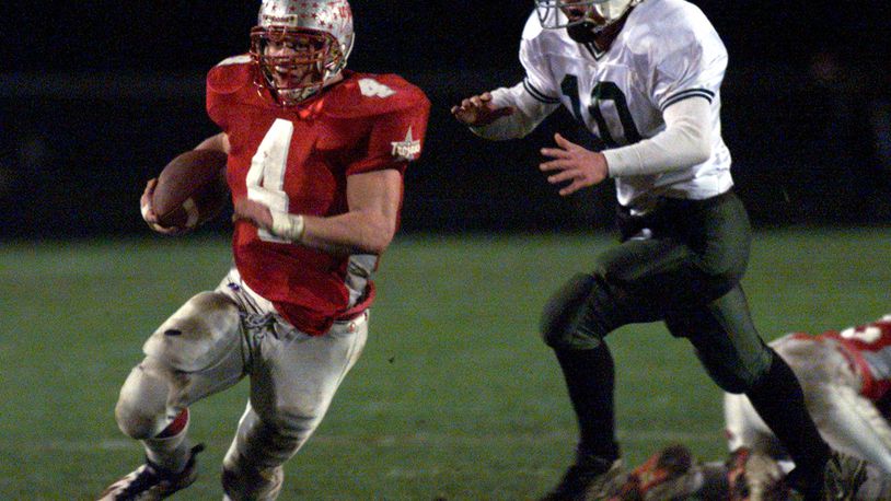 Troy High School's Ryan Brewer runs away from a Greenville defender during a game on Nov. 7, 1998. DDN file