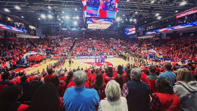 Dayton and Virginia Commonwealth stand for the national anthem before a game on Friday, March 8, 2024, at UD Arena. David Jablonski/Staff