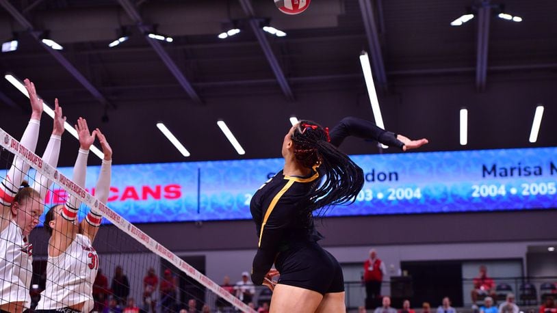 Wright State's Mya Ayro lines up a kill over two Ohio State defenders during a match earlier this month in Columbus. Joe Craven/Wright State Athletics photo