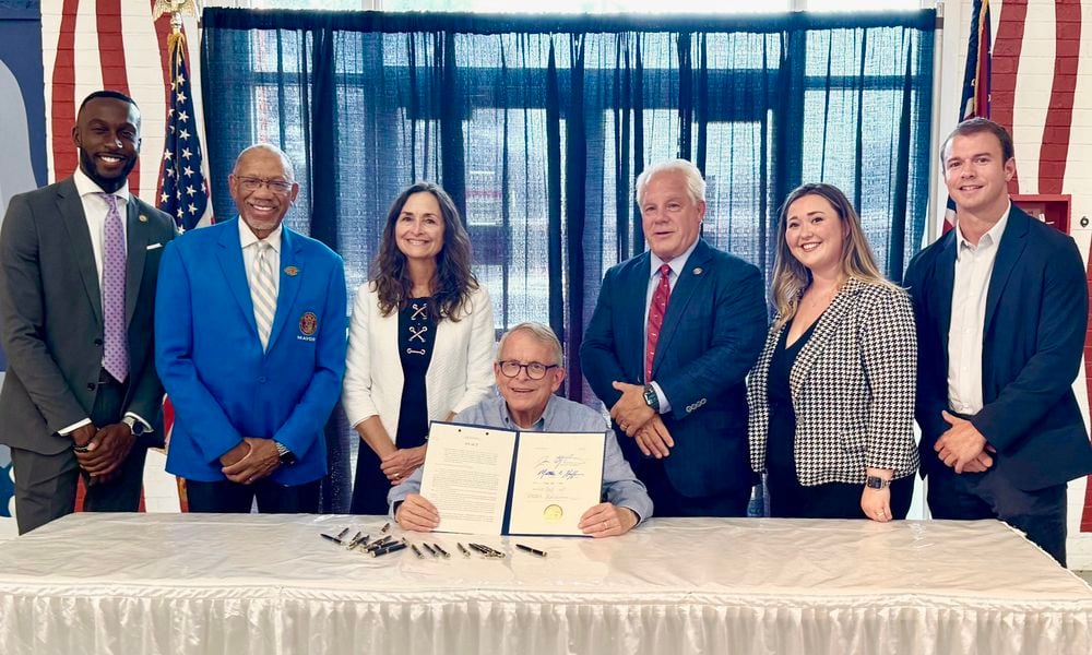 Ohio Gov. Mike DeWine signs an anti-hooning bill that was backed by Dayton Mayor Jeffrey Mims, Jr., along with Dayton-area state legislators Reps. Phil Plummer, R-Butler Twp., and Andrea White, R-Kettering. JULY 24, 2024.