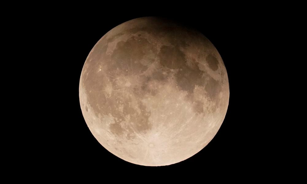 FILE - A supermoon with a partial lunar eclipse rises over Lake Michigan in Chicago, Tuesday, Sept. 17, 2024. (AP Photo/Kiichiro Sato, File)