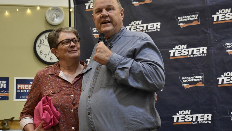 U.S. Sen. Jon Tester, D-Mont., speaks while standing next to his wife, Sharla, at a campaign rally, Thursday, Sept. 5, 2024, in Bozeman, Mont. (AP Photo/Matthew Brown)