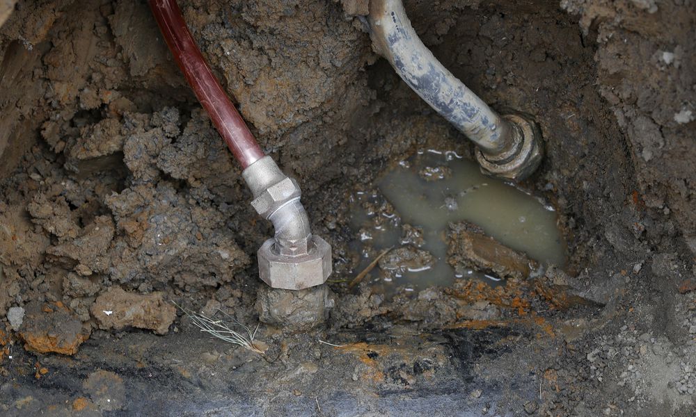 FILE - A copper water supply line, left, is shown connected to a water main after being installed for lead pipe, right, July 20, 2018, in Flint, Mich. (AP Photo/Paul Sancya, File)