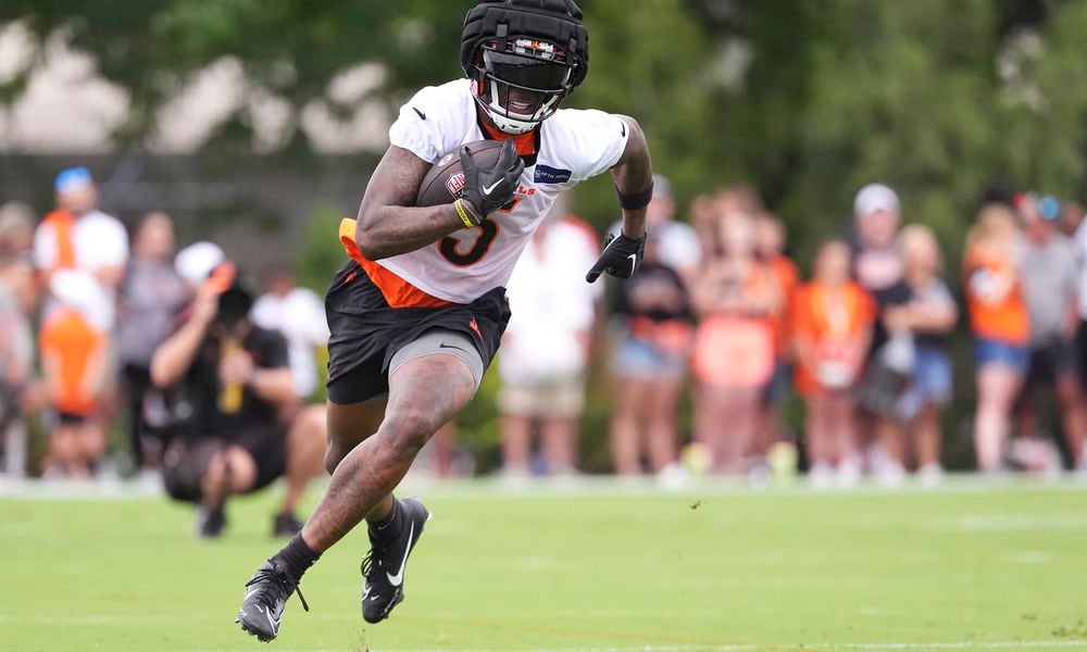 Cincinnati Bengals wide receiver Tee Higgins runs downfield after completing a catch during the team's NFL football training camp Sunday, July 28, 2024, in Cincinnati. (AP Photo/Kareem Elgazzar)