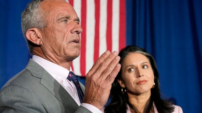 Former Independent candidate for president Robert F. Kennedy, Jr., left, answers a question as former Democratic Rep. Tulsi Gabbard listens as they meet with the media after a campaign event for Republican presidential nominee former President Donald Trump, Saturday, Sept. 14, 2024, in Glendale, Ariz. (AP Photo/Ross D. Franklin)