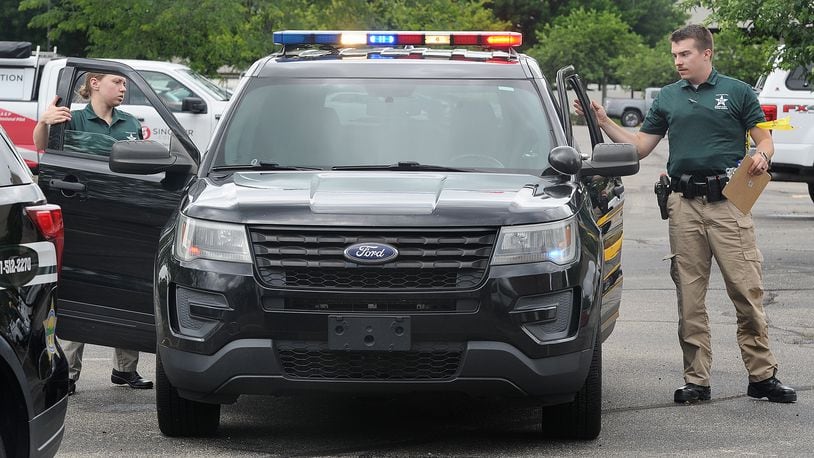 Reporter London Bishop and cadet Noah Thomas exit a cruiser during combined scenarios training at the Sinclair Police Academy. MARSHALL GORBY\STAFF