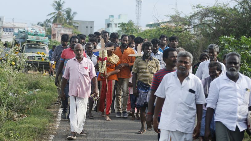 Relatives of a man, who died after drinking illegally brewed liquor, walk in a funeral procession for his burial in Kallakurichi district of the southern Indian state of Tamil Nadu, India, Thursday, June 20, 2024. The state's chief minister M K Stalin said the 34 died after consuming liquor that was tainted with methanol, according to the Press Trust of India news agency. (AP Photo/R. Parthibhan)