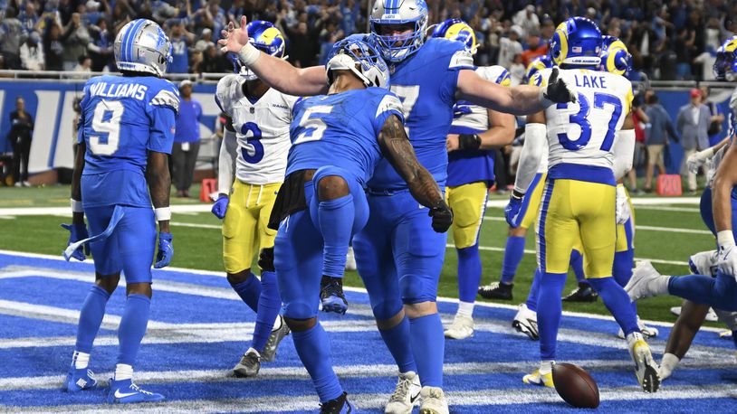 Detroit Lions running back David Montgomery (5) celebrates his one-yard touchdown run against the Los Angeles Rams during overtime in an NFL football game in Detroit, Sunday, Sept. 8, 2024. (AP Photo/David Dermer)