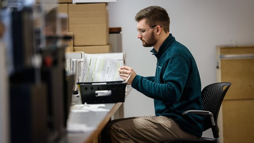 Montgomery County Board of Election worker Chase Aivalotis checks voter registrations Friday September 13, 2024. JIM NOELKER/STAFF