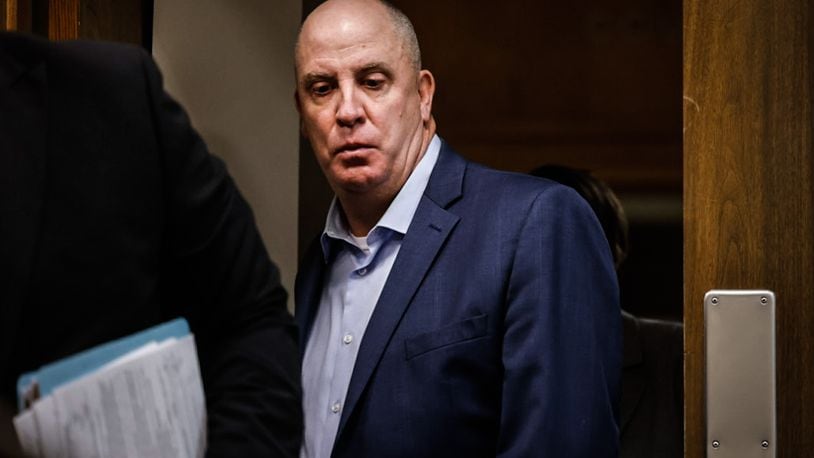 Former Montgomery County prosecutor John Amos enters Judge Daniel Hogan's courtroom Friday morning at the Montgomery County Common Pleas Court. Amos was sentenced for sexual imposition and assault. JIM NOELKER/STAFF