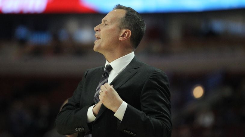 Northwestern coach Chris Collins talks to his team during a game against Dayton. David Jablonski/Staff