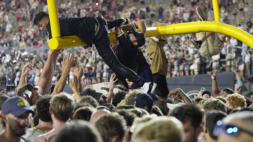 Vanderbilt fans tear down the goal post after the team's 40-35 win against Alabama after an NCAA college football game Saturday, Oct. 5, 2024, in Nashville, Tenn. (AP Photo/George Walker IV)