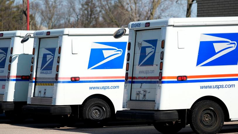 FILE - U.S. Postal Service trucks park outside a post office in Wheeling, Ill., Monday, Jan. 29, 2024. (AP Photo/Nam Y. Huh, File)