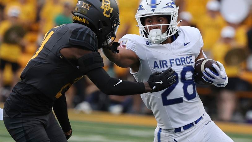 Air Force running back Aiden Calvert stiff-arms Baylor linebacker Keaton Thomas while running toward the sidelines during the first half of an NCAA college football game, Saturday, Sept. 14, 2024, in Waco, Texas. (Rod Aydelotte/Waco Tribune-Herald via AP)