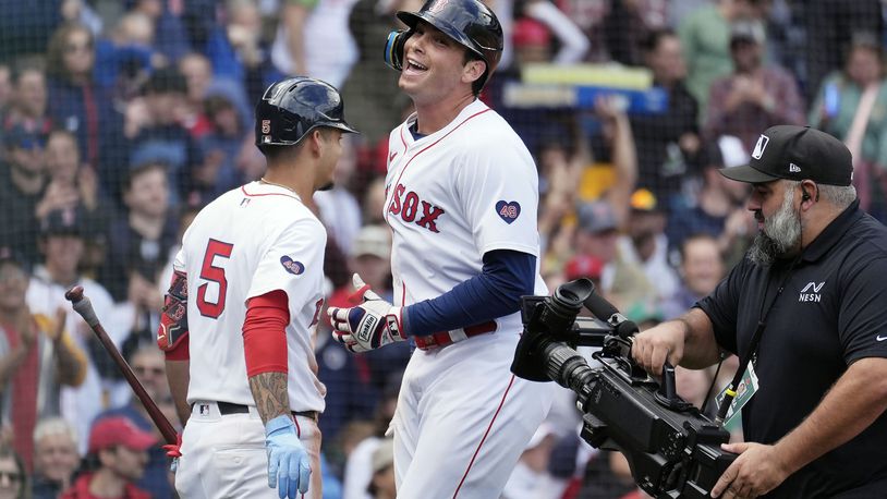 Boston Red Sox's Triston Casas, center, celebrates after his solo home run with Vaughn Grissom (5) during the fifth inning of the first game of a baseball doubleheader against the Minnesota Twins, Sunday, Sept. 22, 2024, in Boston. (AP Photo/Michael Dwyer)