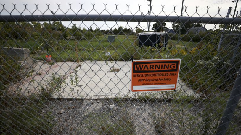 A sign warning of beryllium hangs on a fence at the Luckey FUSRAP (Formerly Utilized Sites Remedial Action Program) site, which was designated as such due to beryllium contamination, in Luckey, Ohio, Wednesday, Sept. 11, 2024. (Kurt Steiss /The Blade via AP)