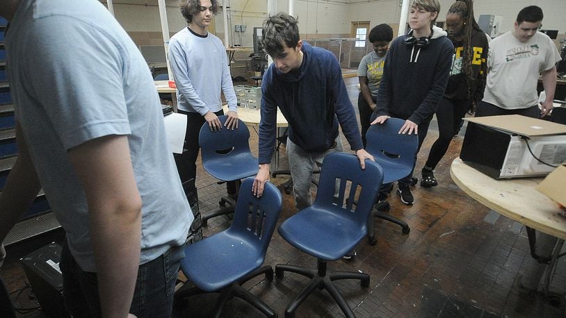 Kettering students help move chairs Tuesday, May 14, 2024. Kettering City Schools is renovating Fairmont High School’s Career Technology Center with a $1.24 million addition for an advanced manufacturing program. MARSHALL GORBY\STAFF