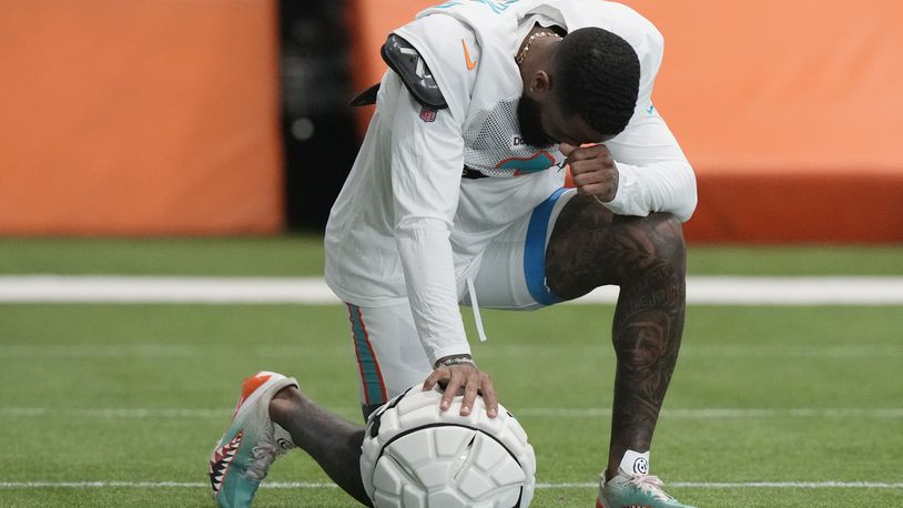 Miami Dolphins wide receiver Odell Beckham Jr. takes a moment during practice at the NFL football team's training facility, Thursday, Oct. 3, 2024, in Miami Gardens, Fla. (AP Photo/Lynne Sladky)