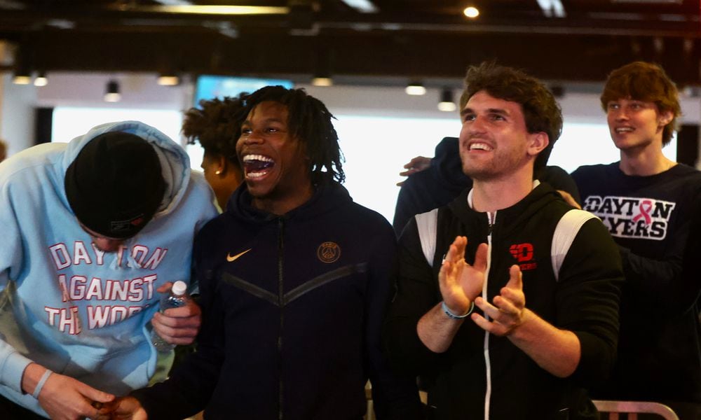 Dayton players (left to right) Isaac Jack, Malachi Smith and Brady Uhl react after hearing their name called on the NCAA tournament Selection Show on Sunday, March 17, 2024, in the Connor Flight Deck at UD Arena. David Jablonski/Staff