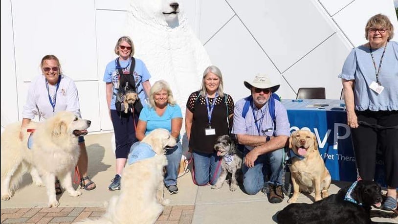 Pam Killingsworth (left) with Tucker, joins other members of the Miami Valley Pet Therapy Association team at the Community Night Out in Trotwood. CONTRIBUTED