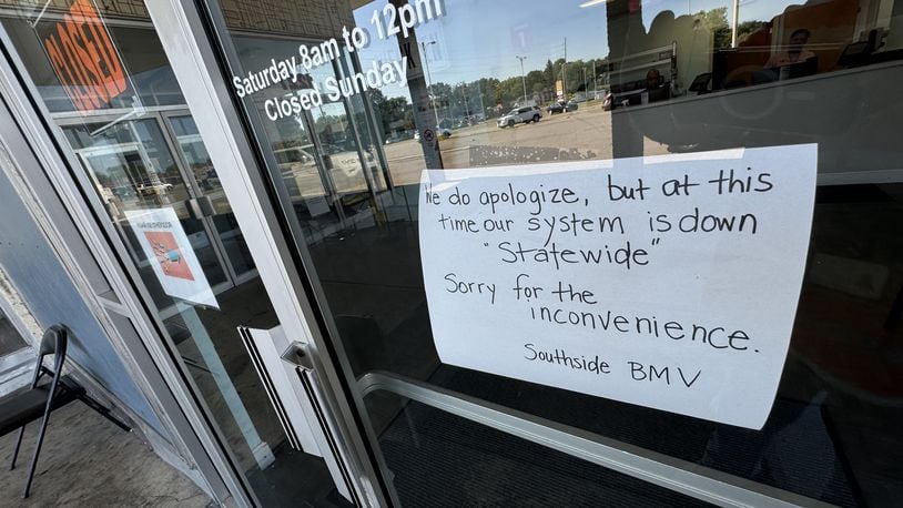 A sign posted to the door at the Ohio BMV site in Springfield Friday morning, July 19, 2024, said the office is closed because its systems are down statewide. BILL LACKEY/STAFF