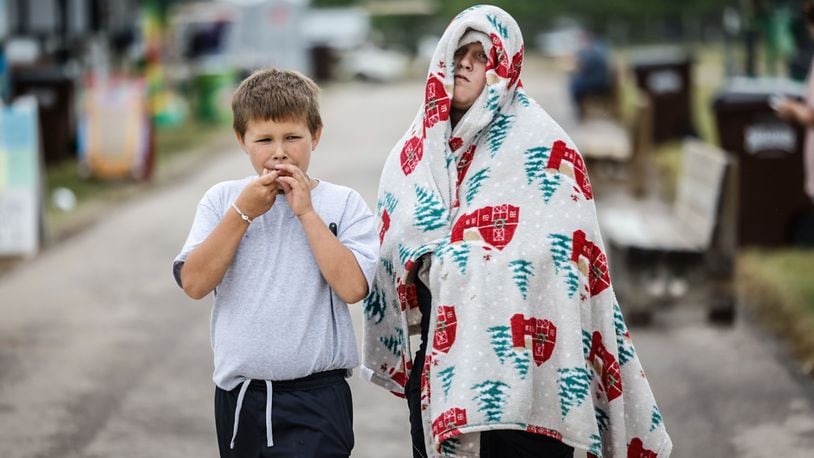 Hudson Cook, left and Brantley Mahan walk around the Montgomery County Fair Wednesday morning  July 10, 2024. Hurricane Beryl brought in cool temperatures and a brisk wind. JIM NOELKER/STAFF