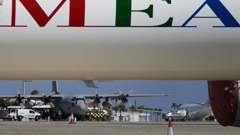 A Greek military transport aircraft carrying Greek and Cypriot citizens evacuated from Lebanon, is seen behind an MEA airlines, after it landed at Larnaca airport, Cyprus, on Thursday, Oct. 3, 2024. (AP Photo/Petros Karadjias)