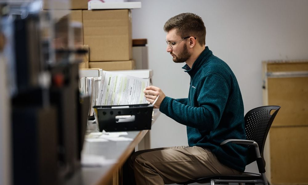 Montgomery County Board of Election worker Chase Aivalotis checks voter registrations Friday September 13, 2024. JIM NOELKER/STAFF