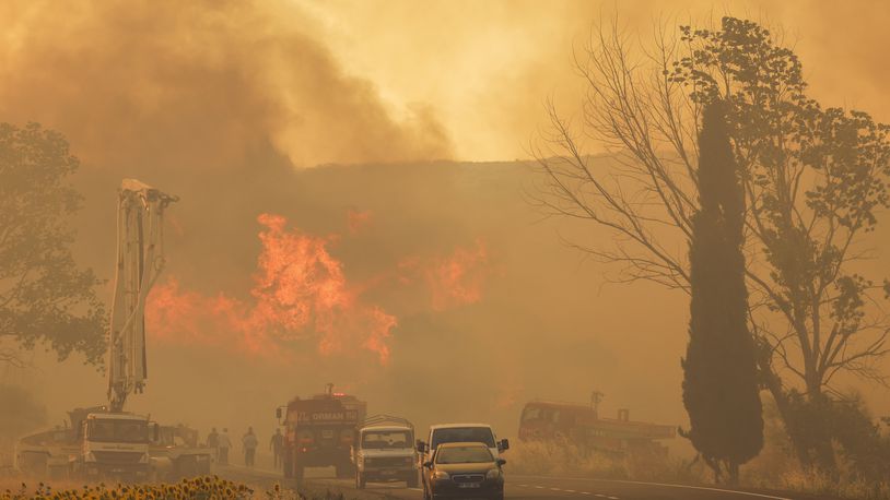 Firefighters work to extinguish a fire burning near Kumkoy, in Gallipoli peninsula, Turkey, Tuesday, June 18, 2024. (Sercan Ozkurnazli/Dia Photo via AP)