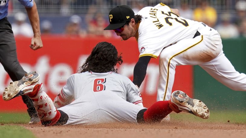 Cincinnati Reds' Jonathan India (6) slides safely into second base with a double ahead of a tag by Pittsburgh Pirates second baseman Alika Williams, right, during the seventh inning of a baseball game Sunday, Aug. 25, 2024, in Pittsburgh. (AP Photo/Matt Freed)