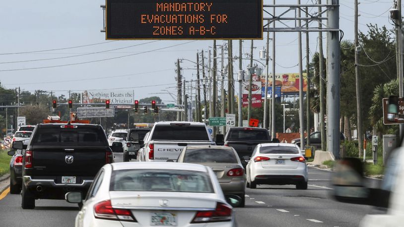 Highway signage announces the impending arrival of Hurricane Milton and the evacuations zones on Tuesday, Oct. 8, 2024, in Port Richey, Fla. (AP Photo/Mike Carlson)