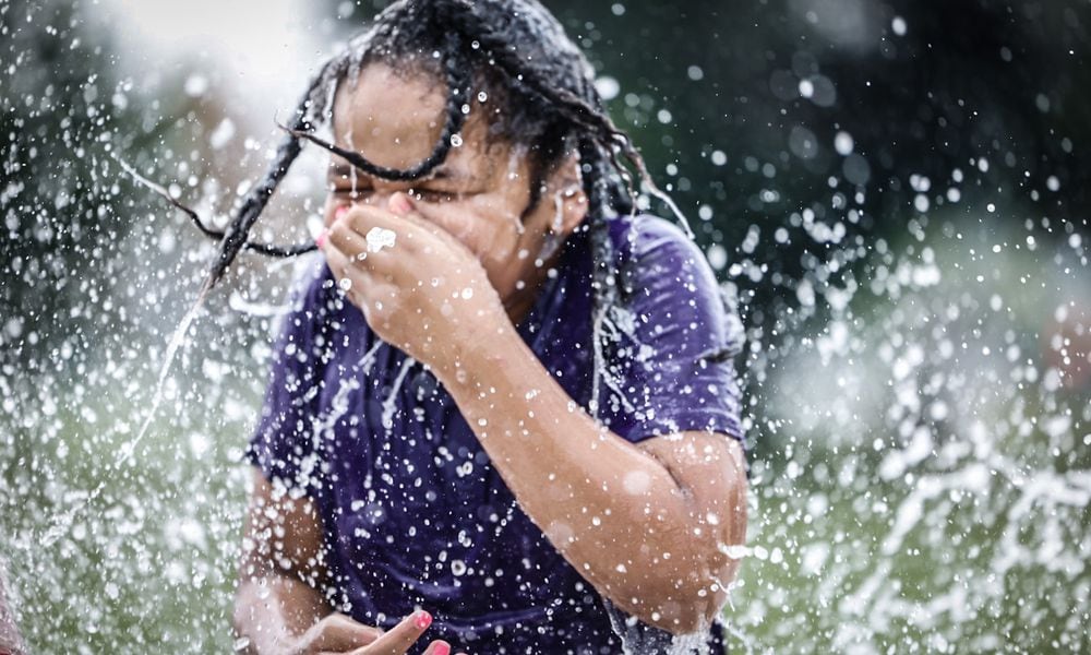 Sirius Sol Mathews, from Dayton, enjoys the splash pad at W.S. Mcintosh Park in Dayton. Temperatures are expected to reach the 90s this week. JIM NOELKER/STAFF