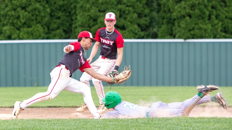 Troy shortstop Ryder Kirtley prepares to tag out a Mason base stealer during the seventh inning of Thursday's Division I district final won by Mason at Centerville High School.