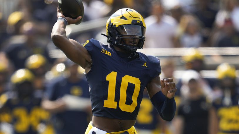 Michigan quarterback Alex Orji (10) throws against Arkansas State in the second half of an NCAA college football game in Ann Arbor, Mich., Saturday, Sept. 14, 2024. (AP Photo/Paul Sancya)