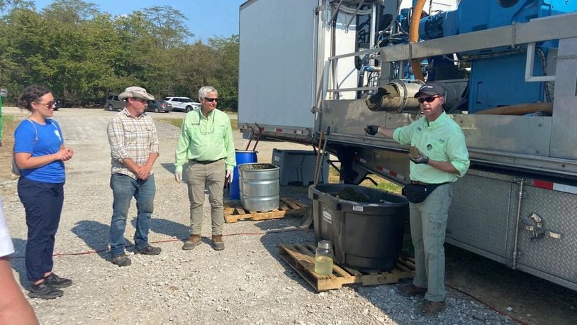 U.S. Army Engineer Research and Development Center’s Martin Page, operational water research team lead, listens as colleagues describe the algal bloom removal unit they developed with industry partner Woolpert at an event at William H. Harsha Lake in Batavia, Ohio in September 2022. Page led the team that developed the system, the research project underpining the freshwater harmful algae removal technology showcased in Ohio. Photo by Holly Kuzmitski