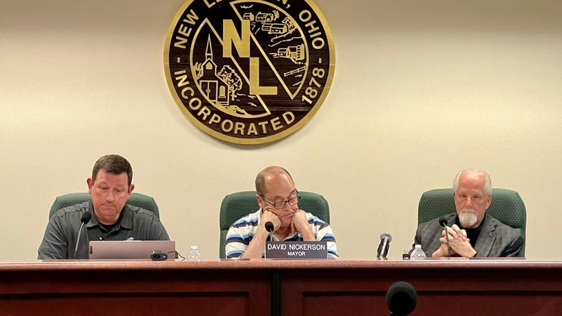 Acting New Lebanon Village Manager Rob Anderson, left, listens to resident comments during a regular meeting on May 7, 2024, along with Mayor David Nickerson, center, and Acting Law Director Michael McNamee. AIMEE HANCOCK/STAFF