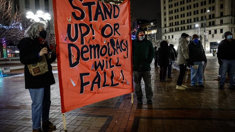 Around 75 people attended a candlelight vigil and rally to remember the January 6 attack on the US capitol at Courthouse Square Thursday night. Jim Noelker/Staff